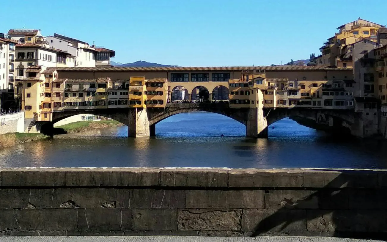 Ponte Vecchio bridge over the Arno River in Florence, part of the self-guided city exploration game.