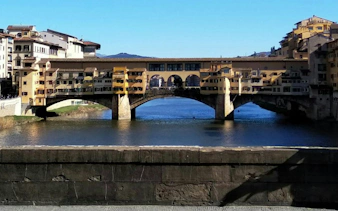 Ponte Vecchio bridge over the Arno River in Florence, part of the self-guided city exploration game.