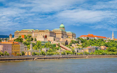 Buda Castle and surrounding buildings in Castle District, Budapest, viewed from across the Danube River.