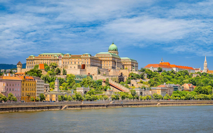 Buda Castle and surrounding buildings in Castle District, Budapest, viewed from across the Danube River.
