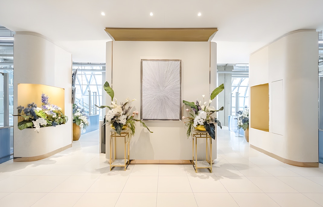 Miracle Lounge entrance with floral arrangements, Bangkok Airport, Thailand.