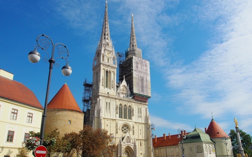 Zagreb Cathedral with scaffolding on a sunny day during a walking tour.