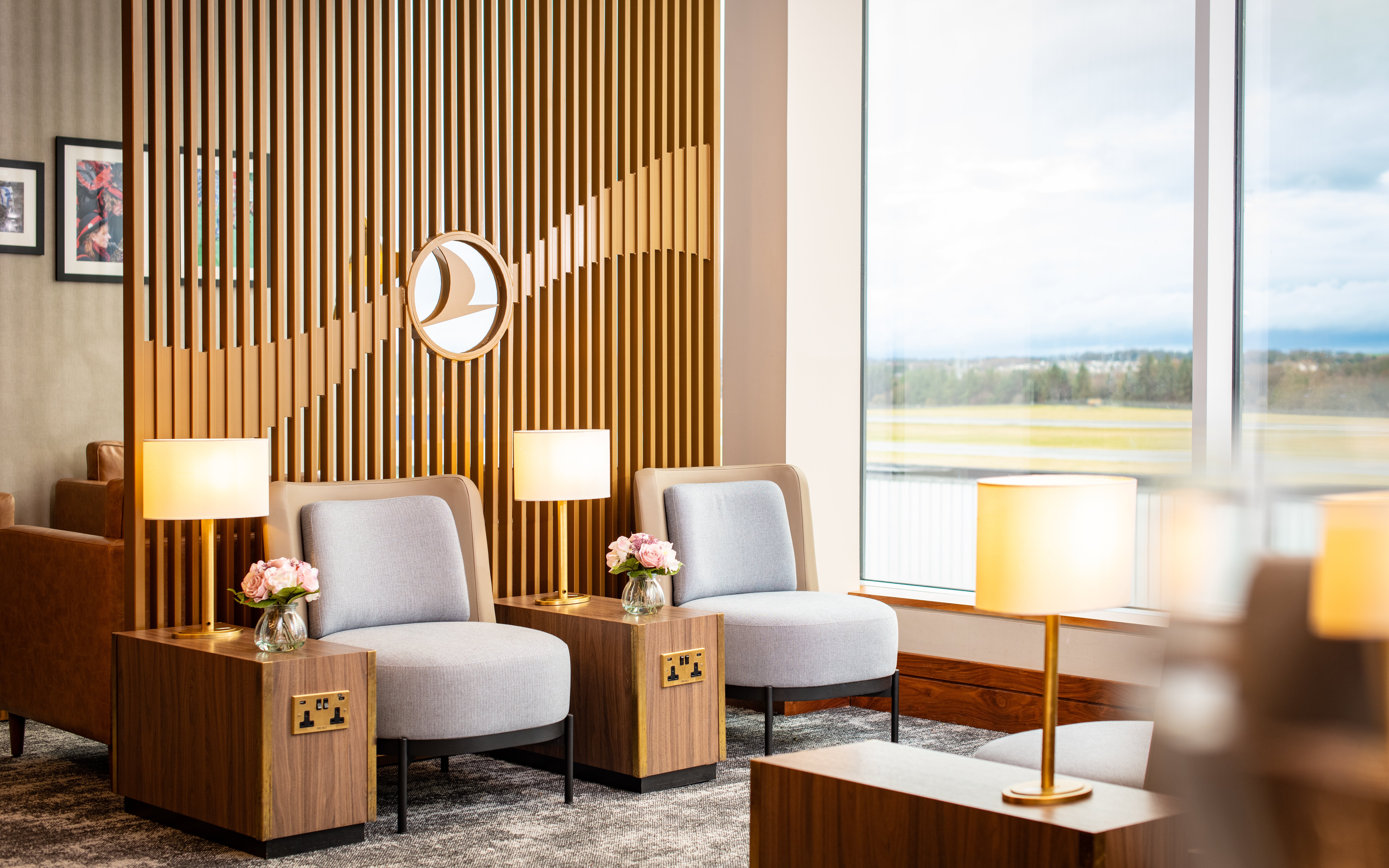 Turkish Airlines Lounge seating area with lamps and view at Edinburgh Airport.