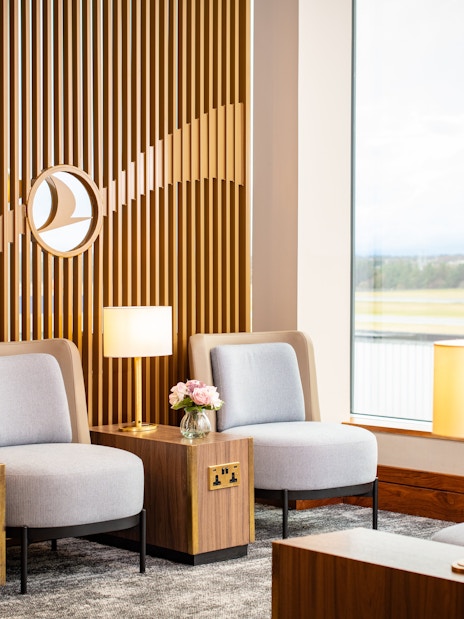 Turkish Airlines Lounge seating area with lamps and view at Edinburgh Airport.