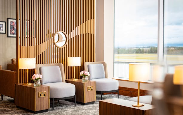 Turkish Airlines Lounge seating area with lamps and view at Edinburgh Airport.