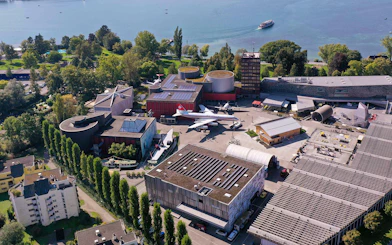 Aerial view of Swiss Museum of Transport in Lucerne with surrounding landscape.
