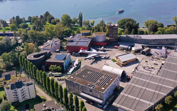 Aerial view of Swiss Museum of Transport in Lucerne with surrounding landscape.