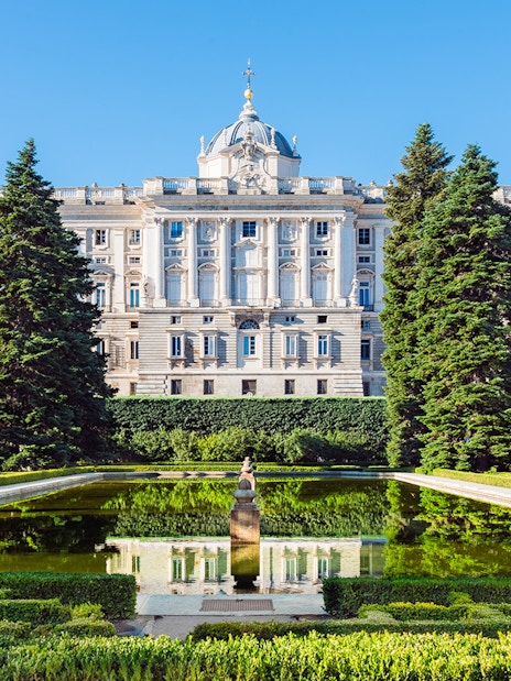 Gardens with statues and pond near the Royal Palace of Madrid.