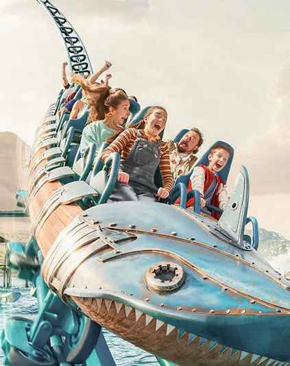 Roller coaster ride with excited passengers at Walibi Belgium.