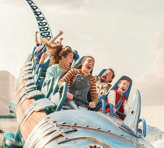 Roller coaster ride with excited passengers at Walibi Belgium.