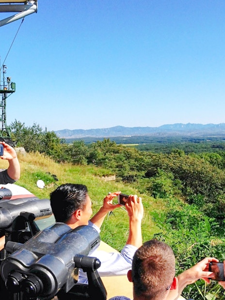Visitors at observatory viewing landscape on Seoul to DMZ tour, South Korea.