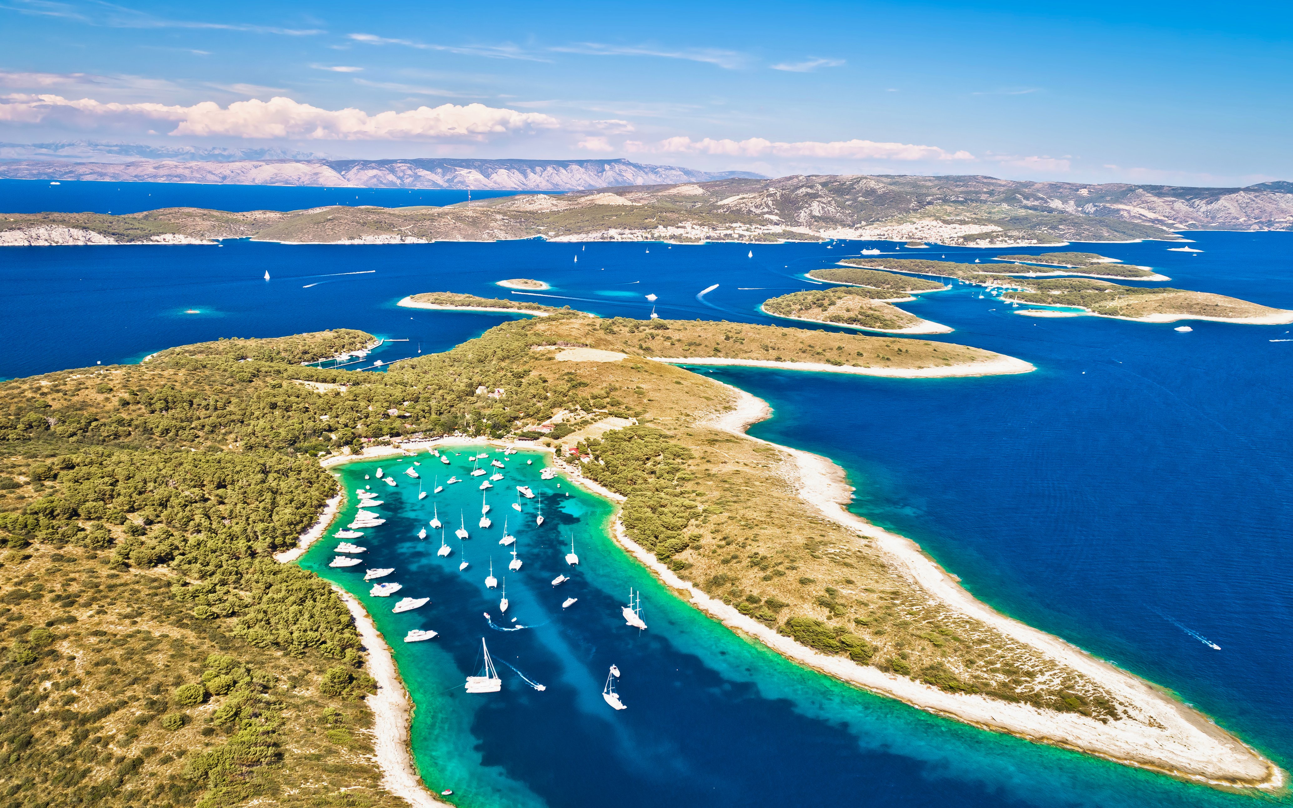 Aerial view of Palmizana cove with sailboats and turquoise waters on Pakleni Otoci islands.