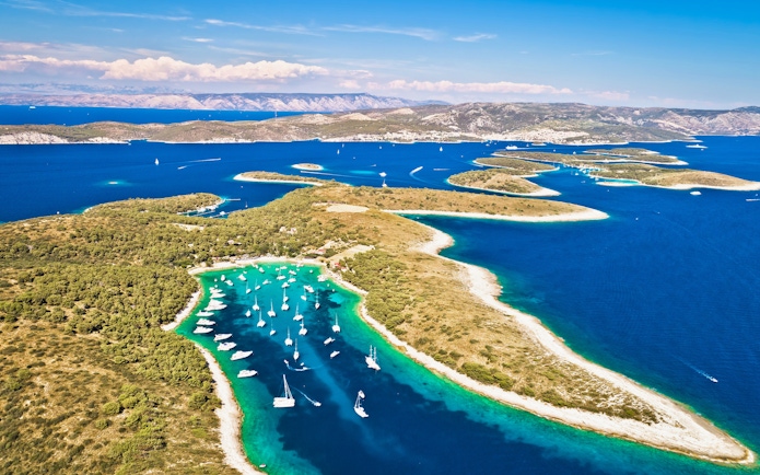 Aerial view of Palmizana cove with sailboats and turquoise waters on Pakleni Otoci islands.