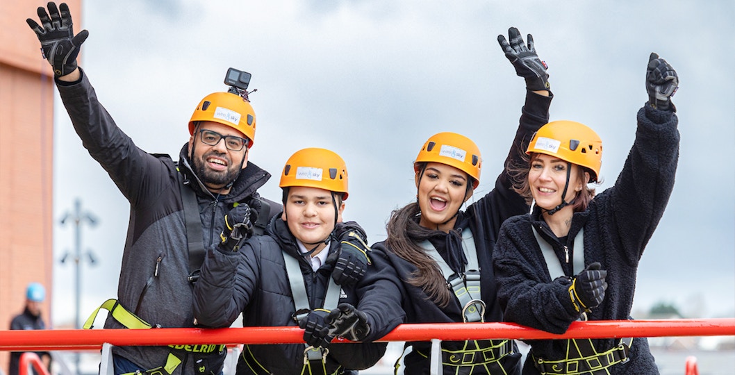 Tourists abseiling on Anfield stadium