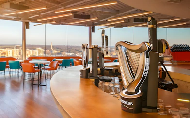 Guinness Storehouse Gravity Bar with city view and harp-shaped beer taps.