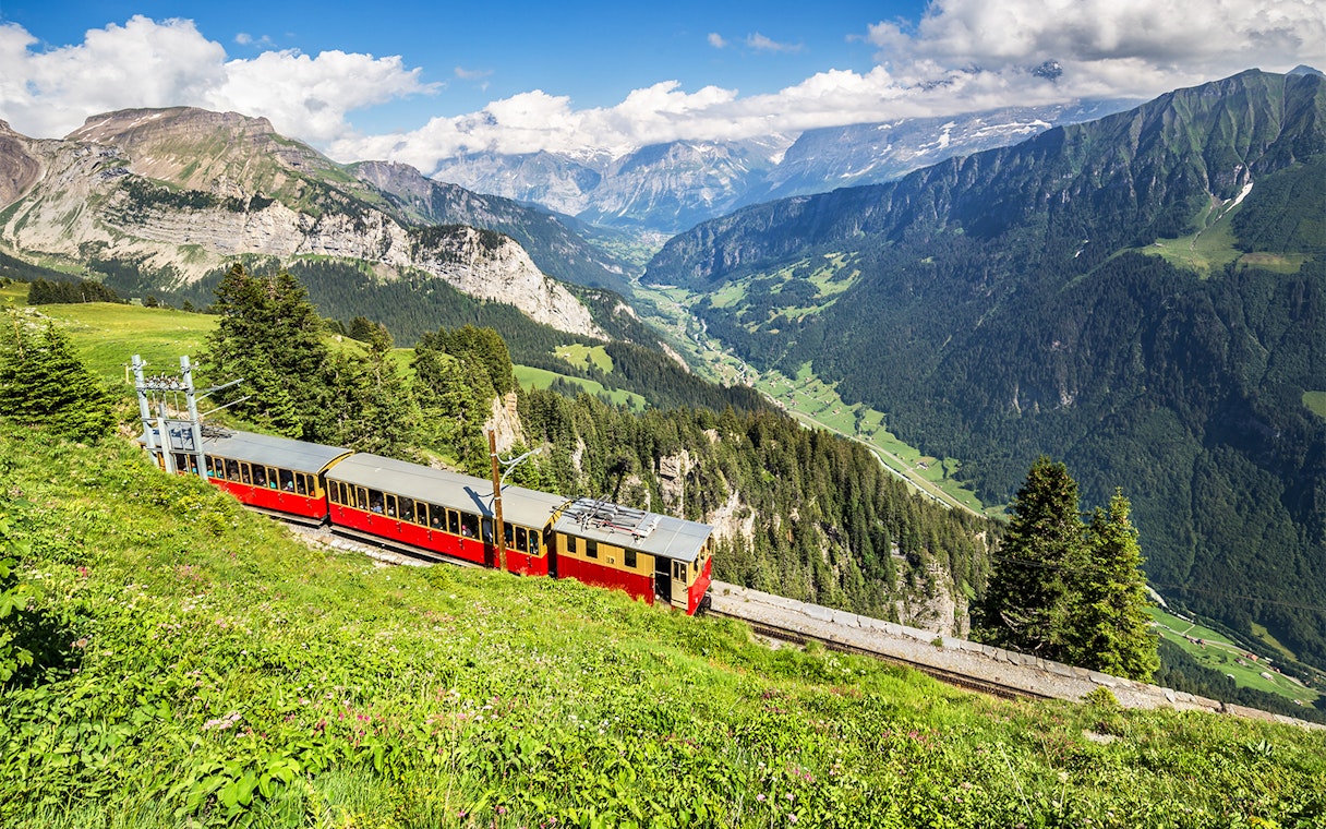Train on Schynige Platte railway with views of Swiss Alps near Interlaken.