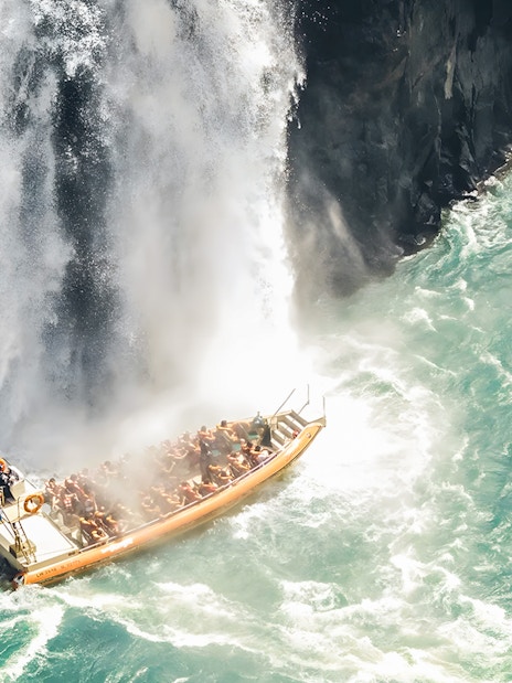 Tourists on a boat near waterfall at Iguazú Falls, Brazilian side.
