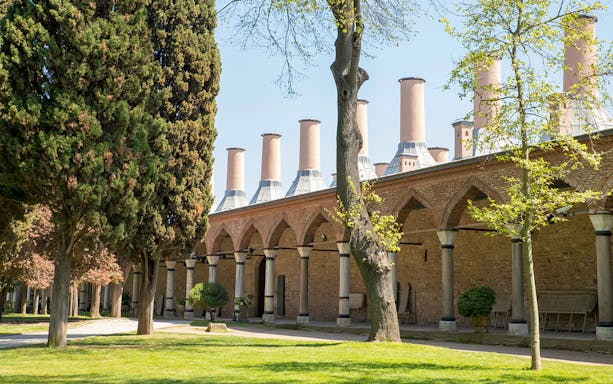 Topkapi Palace kitchen exterior with chimneys and trees, Istanbul.