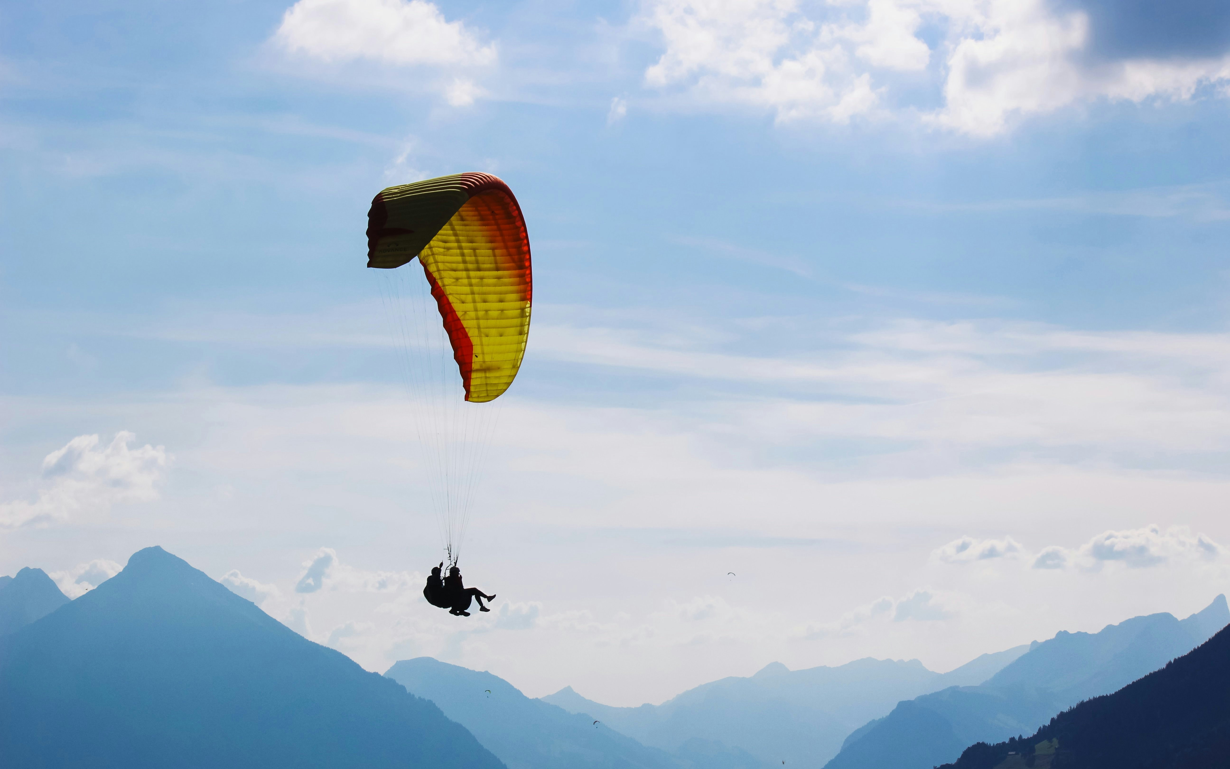 Paragliding over mountains in Interlaken, Switzerland.