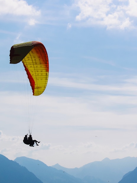 Paragliding over mountains in Interlaken, Switzerland.
