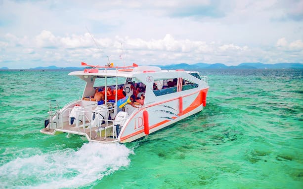 Speed catamaran on turquoise waters during Phuket: Phi Phi, Maya, Koh Khai day tour.
