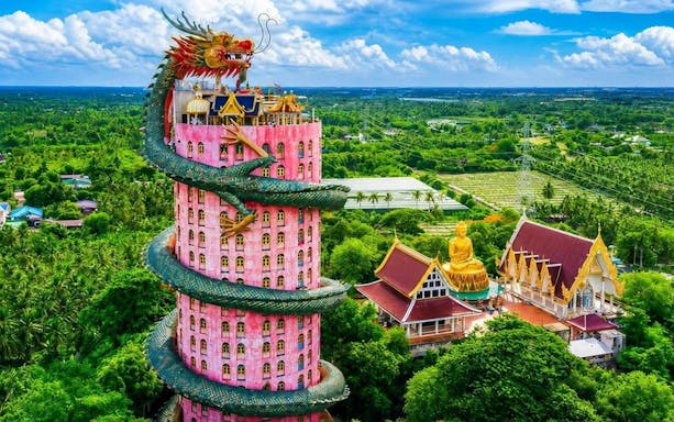 Wat Samphran's pink tower with dragon sculpture in Nakhon Pathom, Thailand.