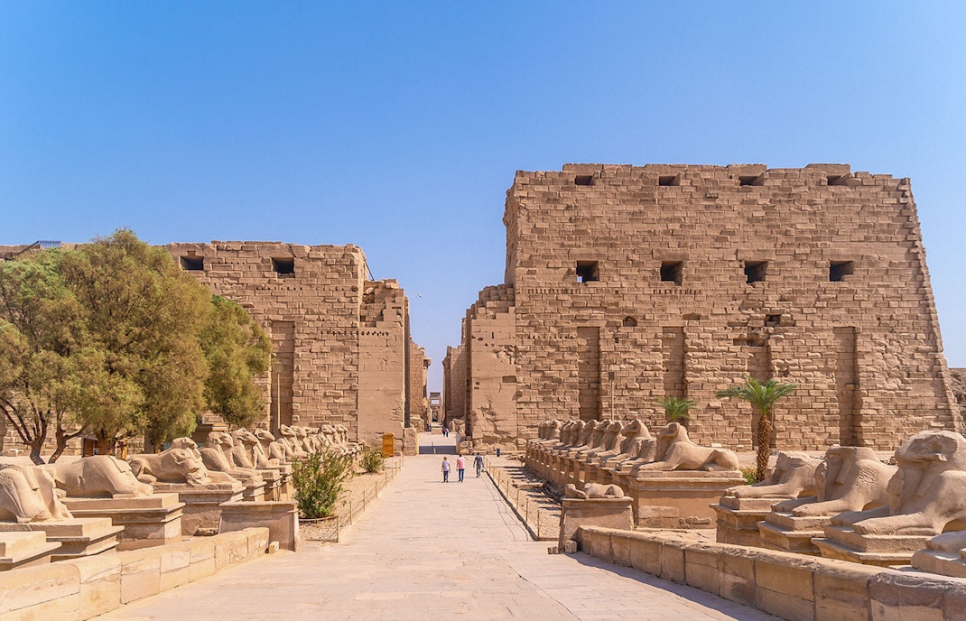 Karnak Temple entrance with ram-headed sphinxes lining the path, Luxor, Egypt.