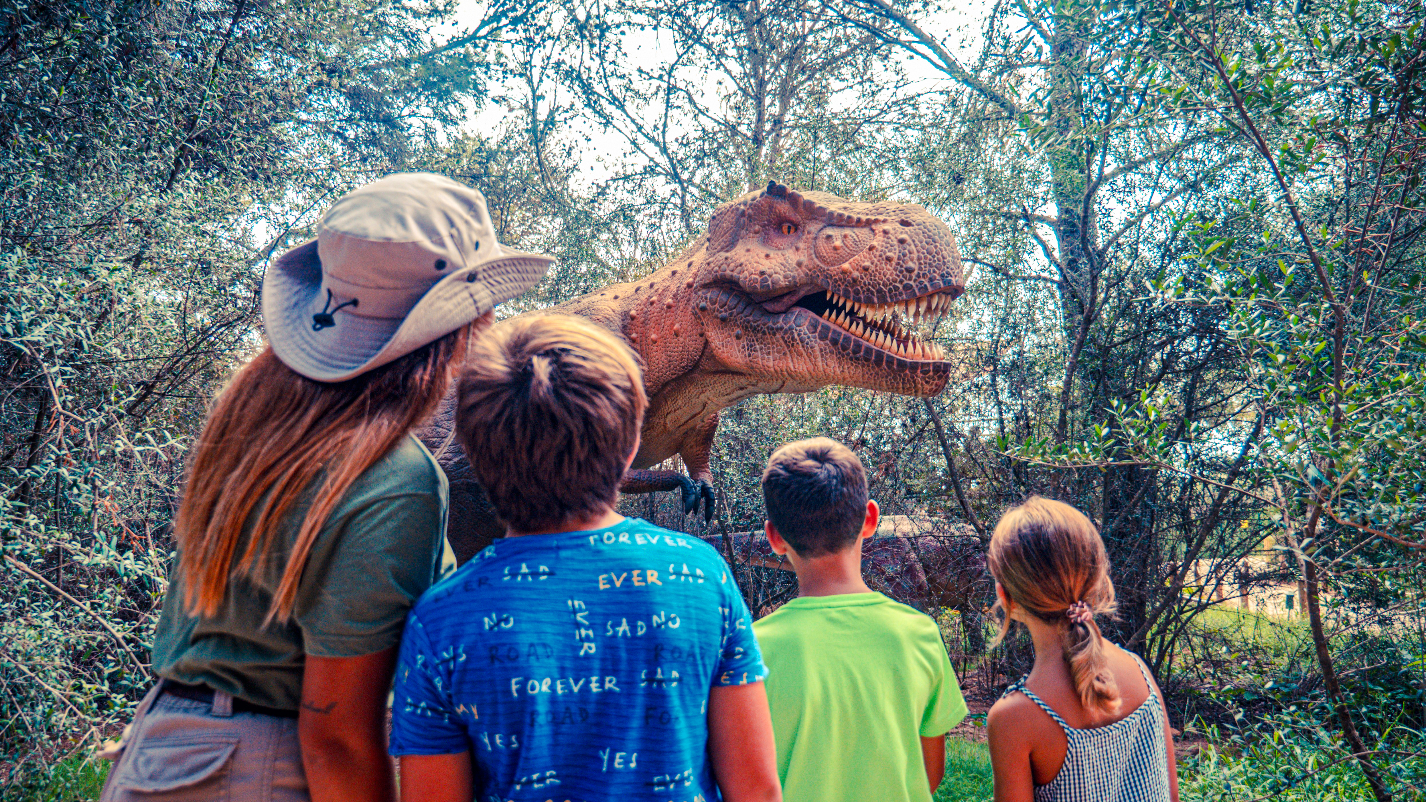 Guests observing a dinosaur exhibit at Dinosaurland, Mallorca.