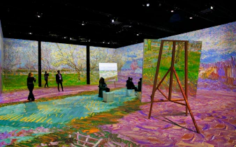 Van Gogh immersive exhibition in Zurich with projected artwork and visitors exploring.