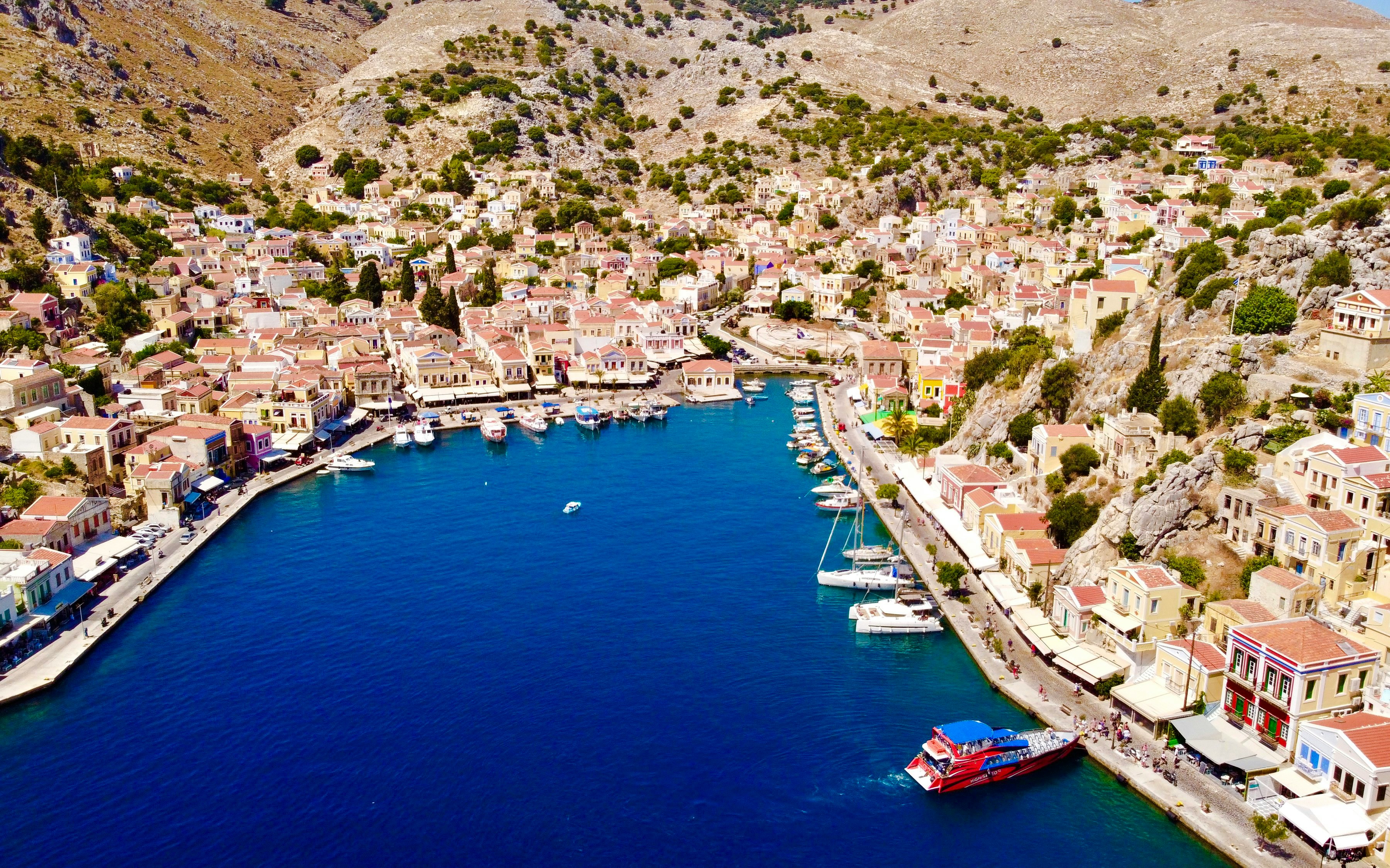 Aerial view of Symi harbor with colorful buildings and boats, Rhodes.