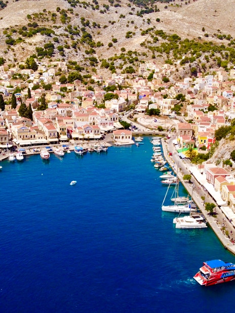 Aerial view of Symi harbor with colorful buildings and boats, Rhodes.