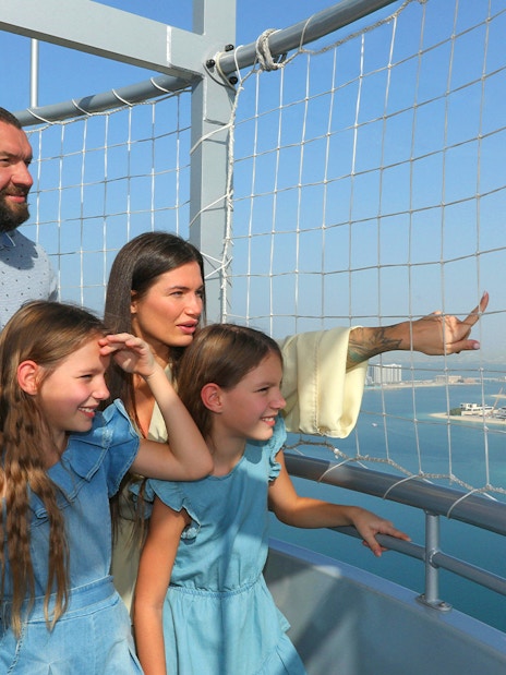 Family enjoying the view from The Dubai Balloon at Atlantis, overlooking the city skyline.