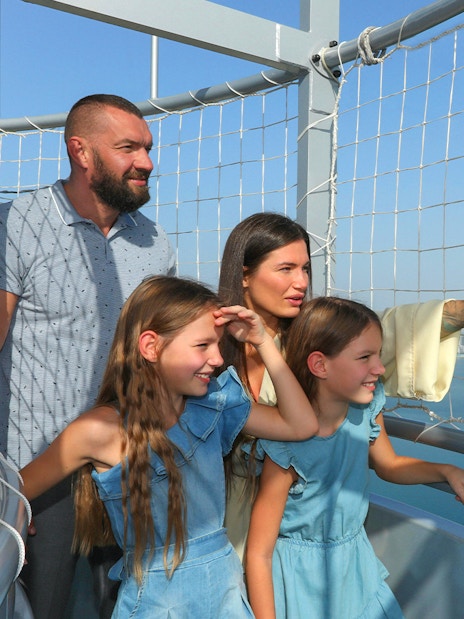 Family enjoying the view from The Dubai Balloon at Atlantis, overlooking the city skyline.
