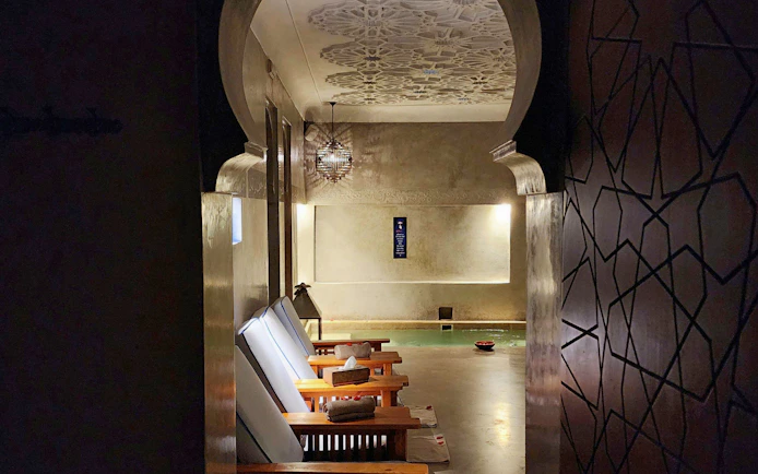 Le Bain Bleu Hammam & Spa interior with lounge chairs and pool, Marrakesh.