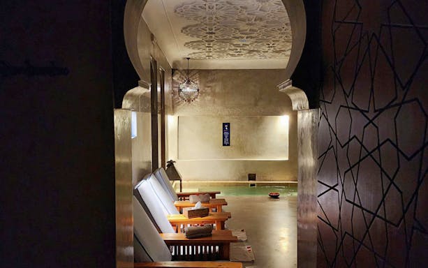 Le Bain Bleu Hammam & Spa interior with lounge chairs and pool, Marrakesh.