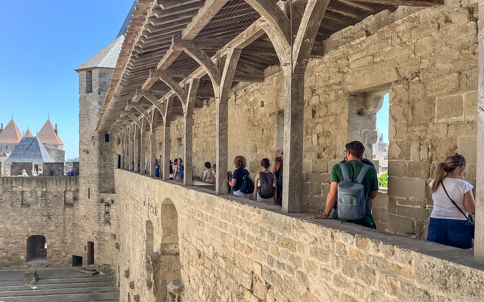 Visitors exploring the ramparts of Carcassonne Castle, France.