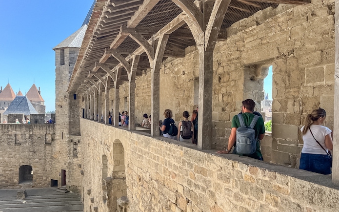 Visitors exploring the ramparts of Carcassonne Castle, France.