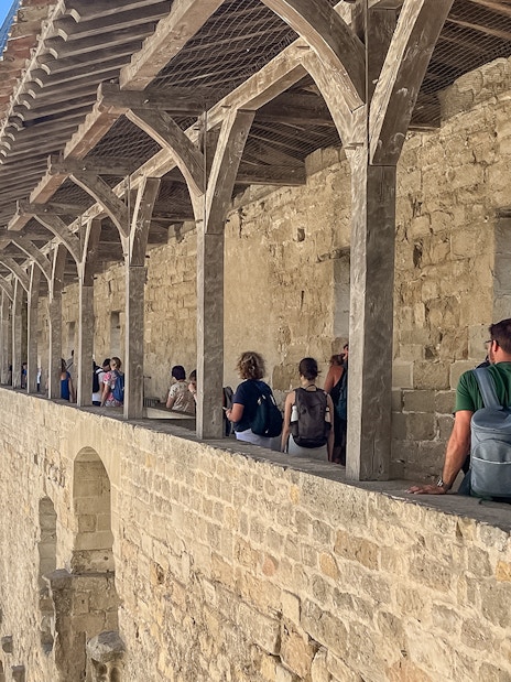 Visitors exploring the ramparts of Carcassonne Castle, France.