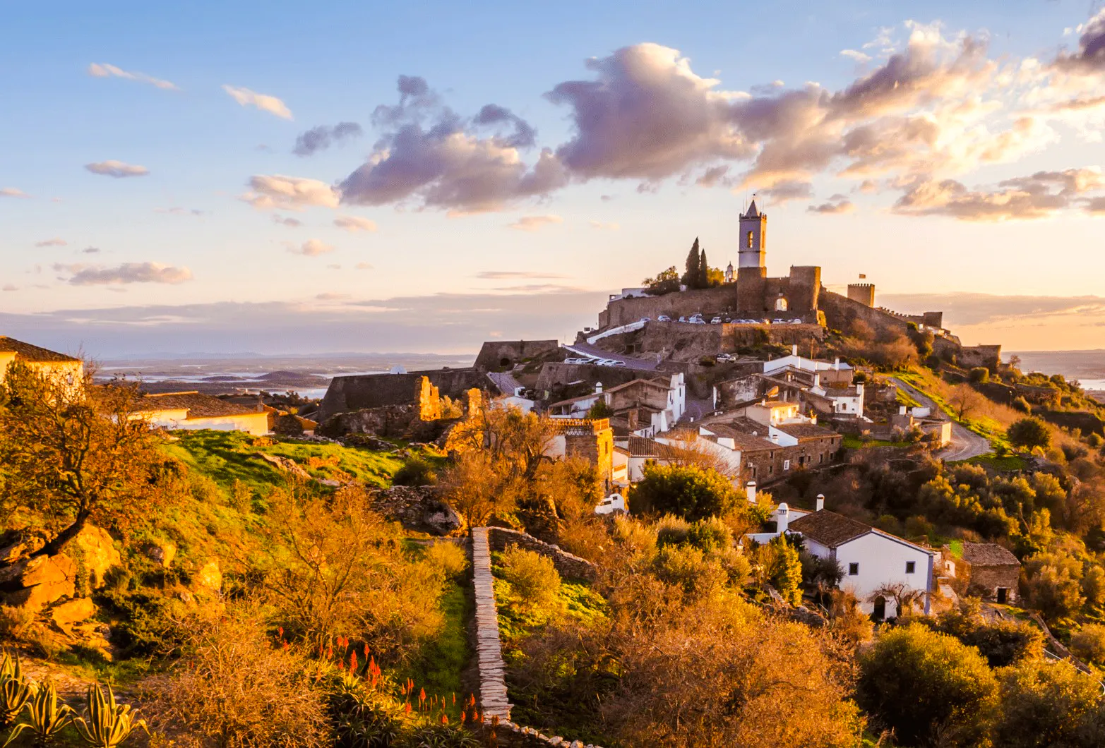 Hilltop view of Monsaraz village with historic buildings and Alentejo landscape, Portugal.