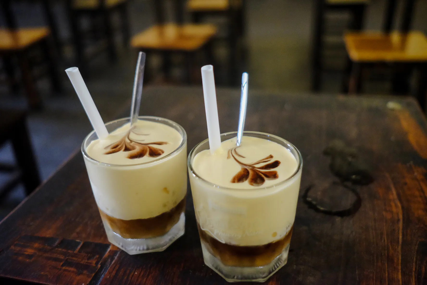 Vietnamese egg coffee on a wooden table during Hanoi Walking Street Food Tour.