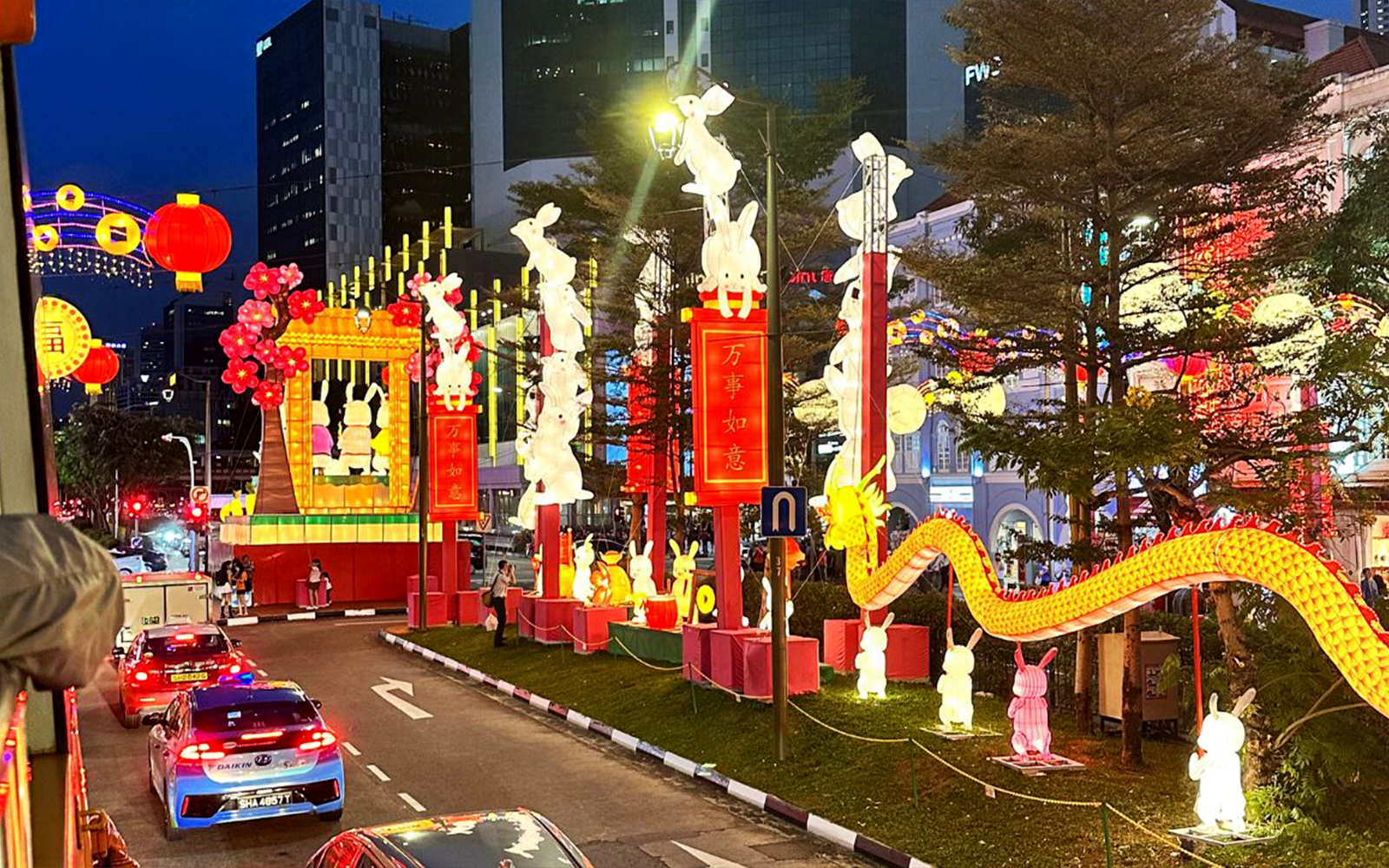 Chinatown night tour with illuminated lanterns and rabbit sculptures.