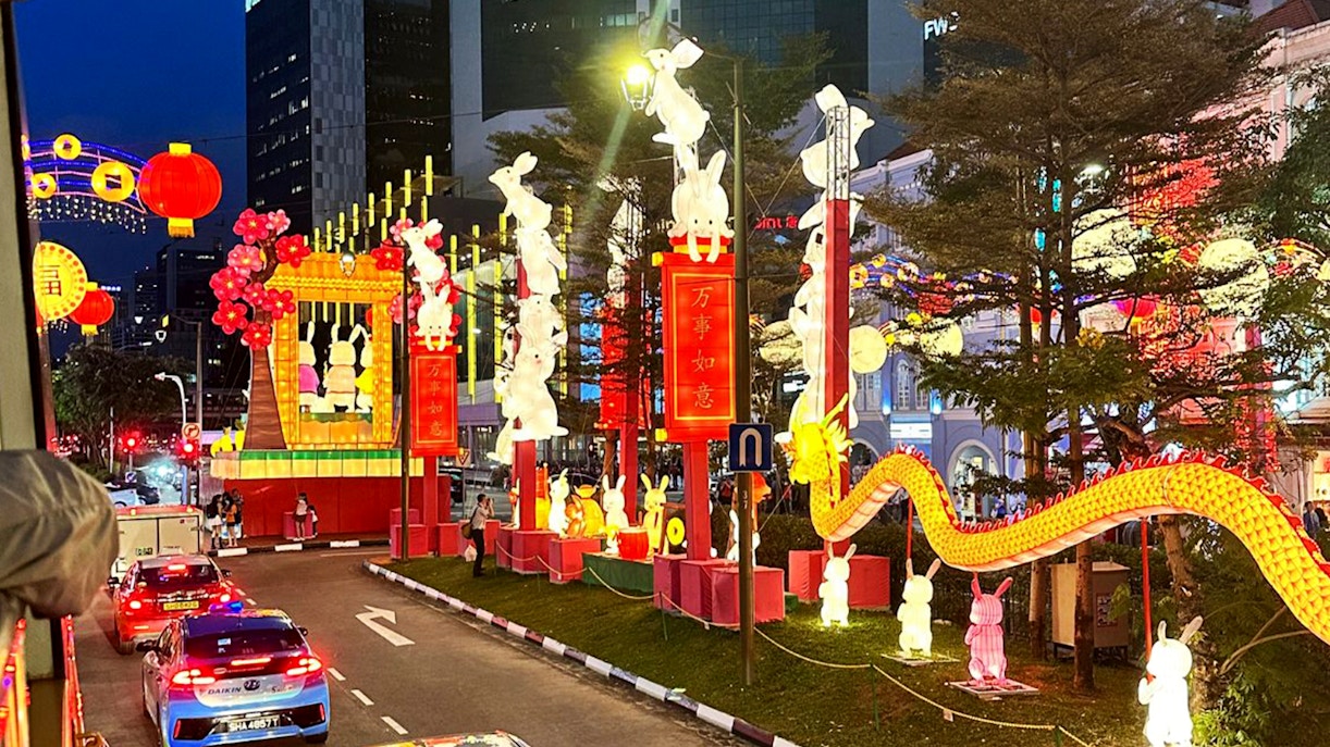 Chinatown night tour with illuminated lanterns and rabbit sculptures.