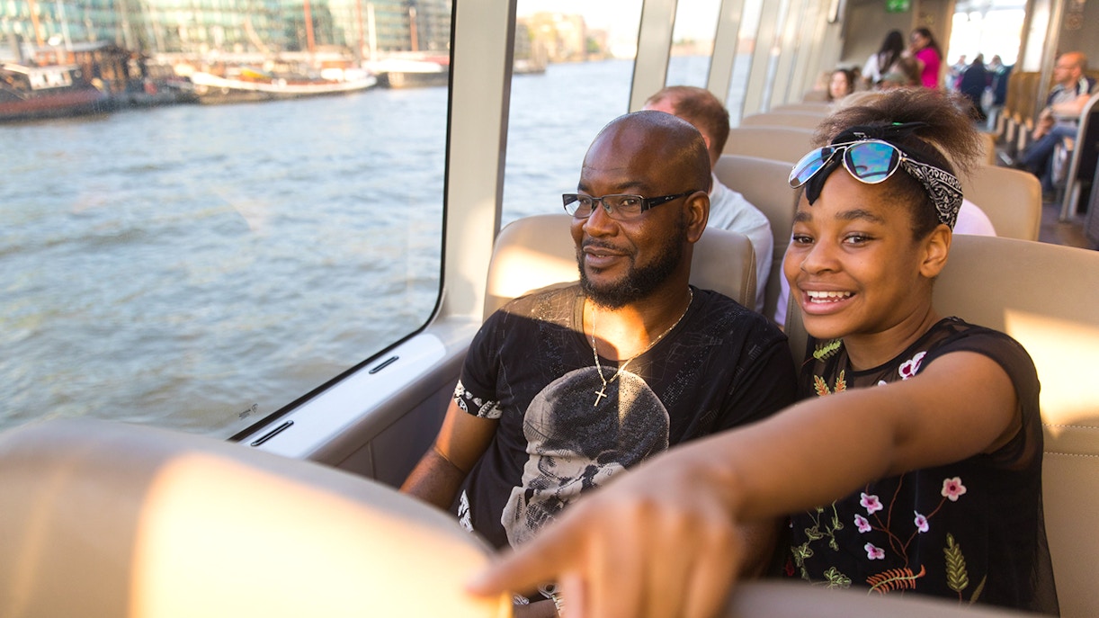 Passengers enjoying a ride on the Thames River Uber Boat in London.