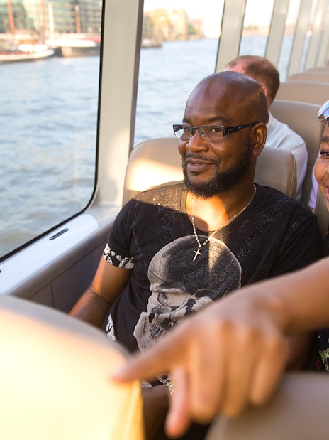 Passengers enjoying a ride on the Thames River Uber Boat in London.
