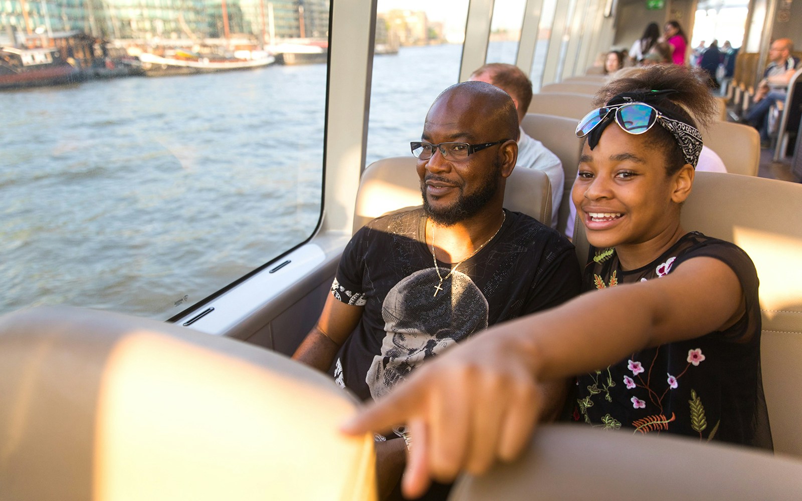 Passengers enjoying a ride on the Thames River Uber Boat in London.