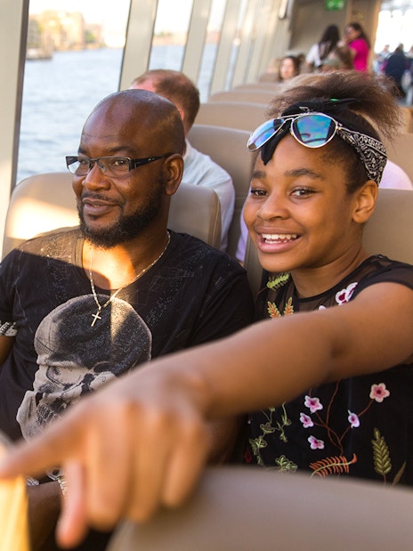 Passengers enjoying a ride on the Thames River Uber Boat in London.