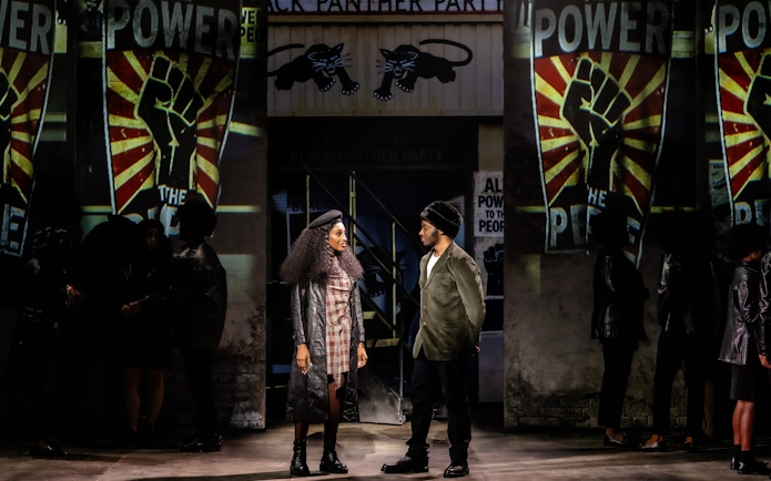 Stage performance of "I'm Every Woman" in Westend with actors in front of Black Panther Party backdrop.