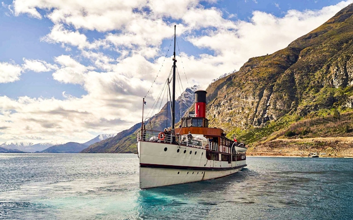TSS Earnslaw steamboat cruising on Lake Wakatipu with mountain backdrop, Queenstown.