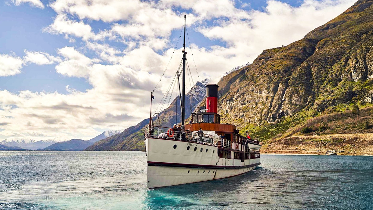 TSS Earnslaw steamboat cruising on Lake Wakatipu with mountain backdrop, Queenstown.