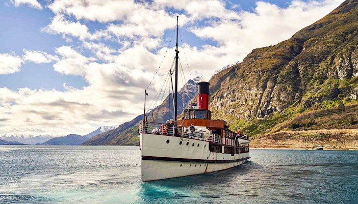TSS Earnslaw steamboat cruising on Lake Wakatipu with mountain backdrop, Queenstown.